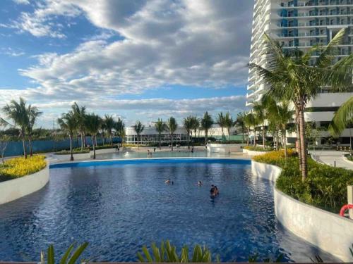 a swimming pool in a resort with people in it at Haldis Suites in San Fernando