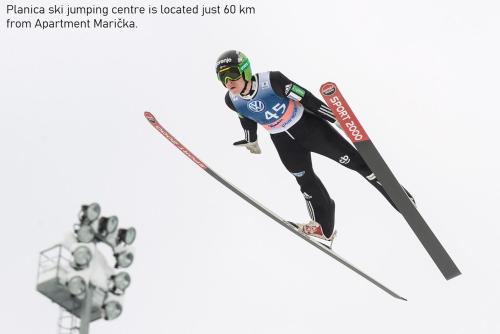 a skier is in the air while jumping at Apartma Marička in Križe