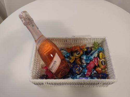a container of candy and a bottle of alcohol at Apartament pod Chełmcem in Szczawno-Zdrój