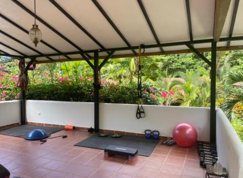 an outdoor room with a large tent with yoga mats at The Scarlet Villas in Ojochal