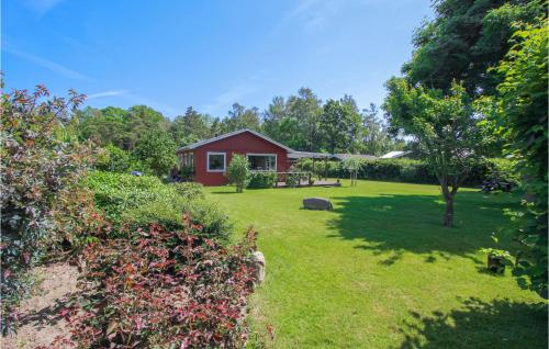 a red house in the middle of a yard at 2 Bedroom Beautiful Home In Samsø in Onsbjerg