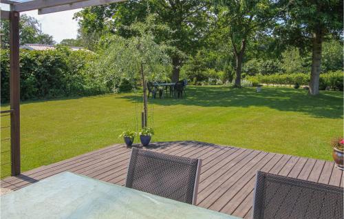 a patio with a table and two chairs and a lawn at 2 Bedroom Beautiful Home In Samsø in Onsbjerg