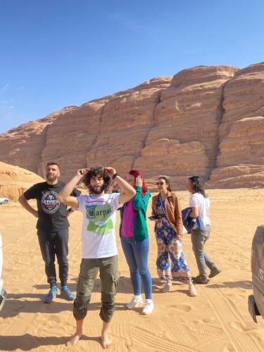 a group of people standing in the desert at wadi rum land mars in Wadi Rum