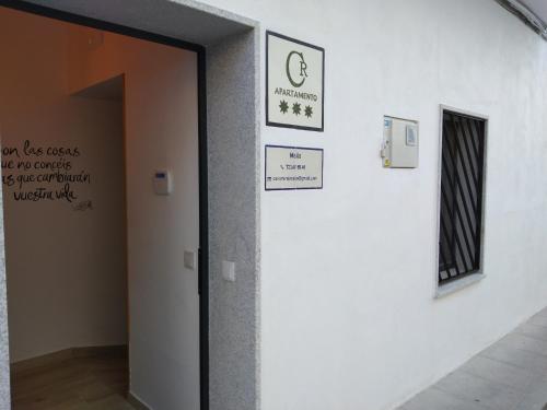a door to a room with signs on the wall at Casa rural Maila in Malpartida de Cáceres