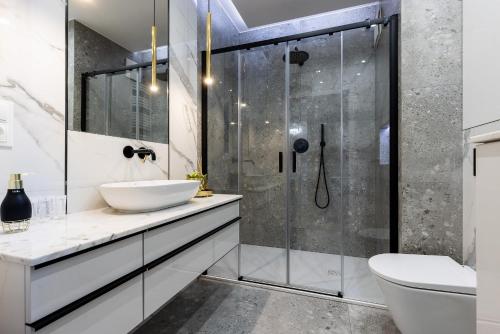 a bathroom with a sink and a shower at Dream Apartment Portova Gdynia in Gdynia