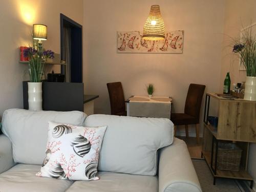 a living room with a white couch with a pillow at Quartier 29 in Eutin