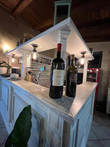 two bottles of wine sitting on a counter in a kitchen at Borgo di Santa Barbara in Santa Domenica