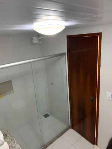 a bathroom with a shower and a glass door at JL Temporadas q 222 PortobelloPark in Porto Seguro
