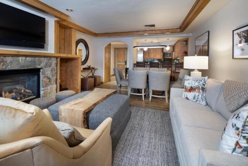 a living room with a couch and a fireplace at Gravity Haus Vail in Vail