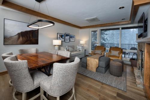 a dining room with a wooden table and chairs at Gravity Haus Vail in Vail