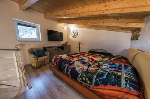 a bedroom with a bed and a chair in a room at Casa Adelina nel Centro dei Sassi in Matera