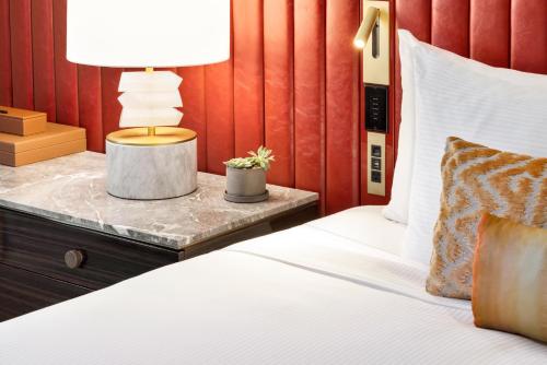 a bedroom with a bed with a table with a lamp at Fairmont Banff Springs in Banff