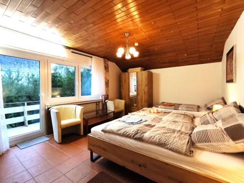 a bedroom with a large bed with a wooden ceiling at Neue moderne ganze 90 qm² Ferienwohnung Berta in Brilon Madfeld in Brilon