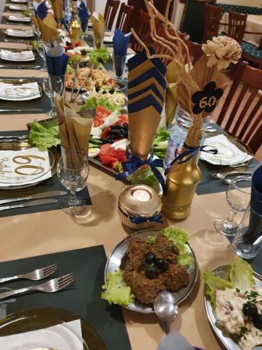 a long table with plates of food on it at Hotel Perfect in Yamna