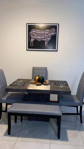 a table with two chairs and a table with fruit on it at Casa totalmente nueva in Colima