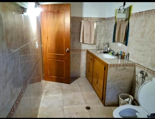 a bathroom with a sink and a shower and a toilet at Hospedaje Mérida in San Rafael