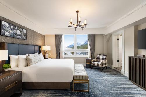 a hotel room with a bed and a chair at Fairmont Banff Springs in Banff