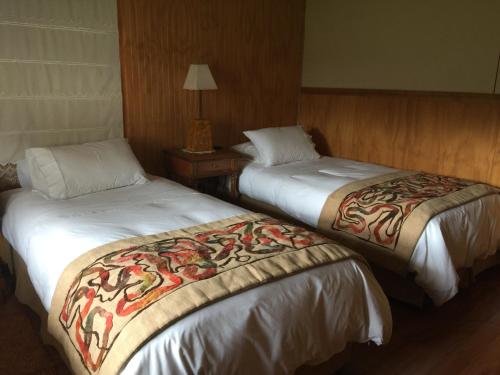 Łóżko lub łóżka w pokoju w obiekcie Keoken Patagonia