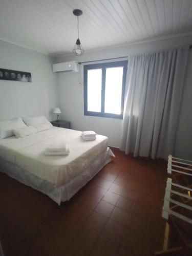 a bedroom with a large bed and a window at La casita in Puerto Iguazú
