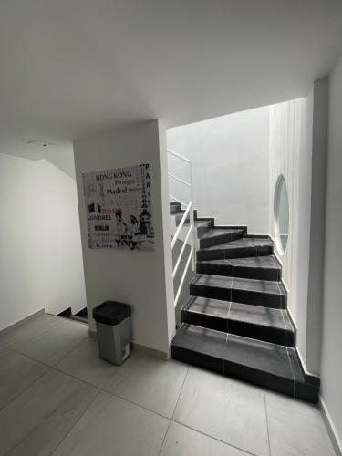 a staircase in a white building with a stair case at Ingenio Park 83 - Apartahotel in Cali