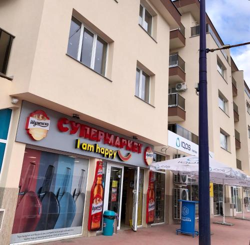 a store front of a building with a sign that reads happy market i can happy at Luxury apartment 1 Free Underground Secure Parking in Pazardzhik