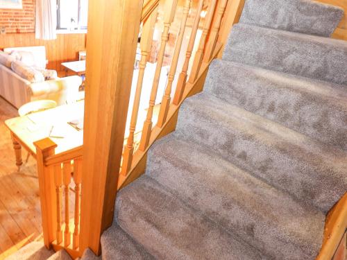 a staircase in a house with a living room at The Dairy Barn in Fakenham