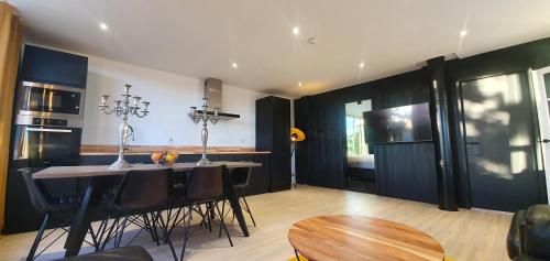 a kitchen with a table and chairs in a room at Contemporary Dublin Suite in Lispapple Cross Roads