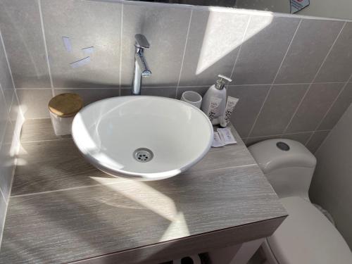 a bathroom with a sink and a toilet at Casa llena de naturaleza y paz perfecta para descansar. in San Miguel