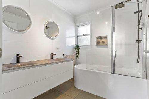 a white bathroom with a sink and a shower at Peaceful Family Villa, Sunrise Beach in Sunrise Beach