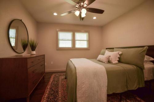 a bedroom with a bed and a ceiling fan at Old Town Bungalow - 4 blocks to Historic Square in Georgetown