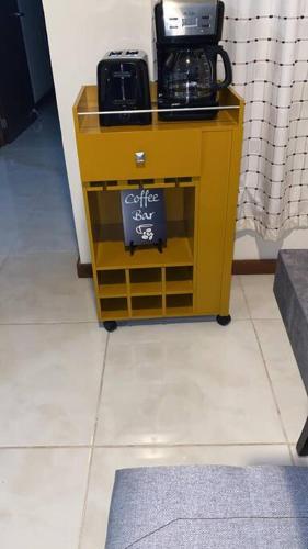 a yellow cart with a coffee maker on it at Casa totalmente nueva,2 cuartos 2 baños -Muy Segura in Colima