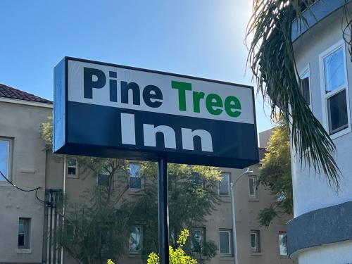 a pine tree inn sign in front of a building at Pine tree inn in Los Angeles