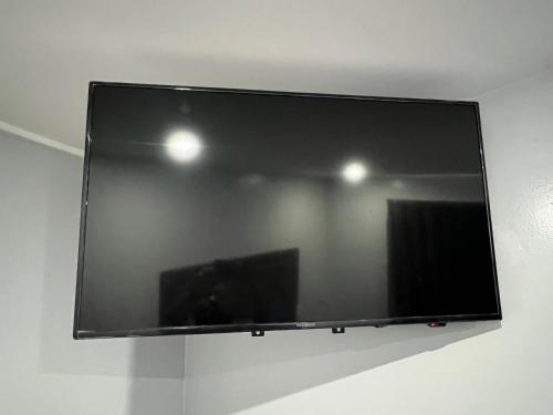a flat screen tv hanging on a wall at Pine tree inn in Los Angeles