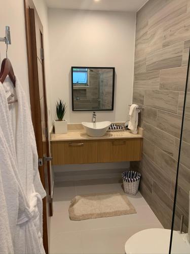a bathroom with a sink and a mirror at Stylish Luxury San Juan Lakes Villa in Gated Community in Downtown Punta Cana With Private Pool in Punta Cana
