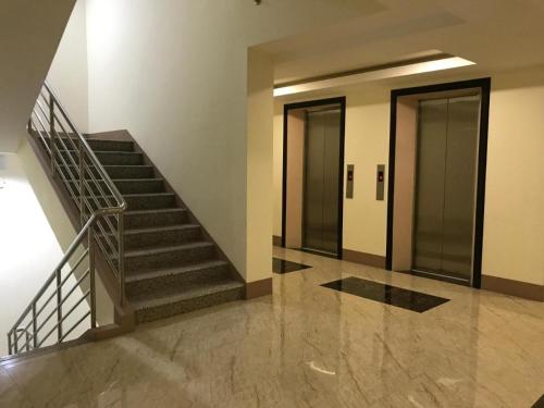 a hallway with stairs and elevators in a building at Megatower 3 - Close to Session Road - City Center in Baguio