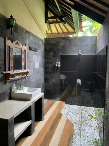 a bathroom with a sink and a shower at Tradisi Villas in Amed
