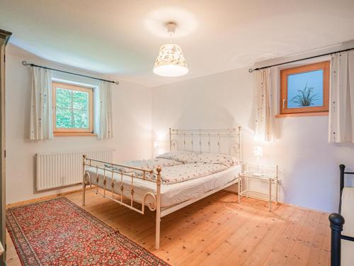 a bedroom with a bed and a window and a rug at Rantsch Gebirgsbach in Westendorf