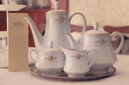 a group of tea sets on a plate with a tea pot at Hemsworth Estate in Elgin