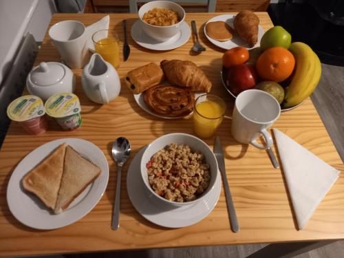 a wooden table topped with plates of breakfast foods at Sea Crest B&B Rossnowlagh in Rossnowlagh