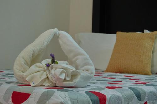 a towel animal is sitting on a bed at Hotel del Alba Inn & Suites in Aguascalientes