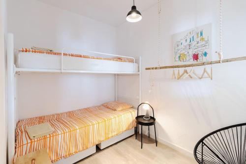a bedroom with a bunk bed and a chair at Casa Levante in Sagres