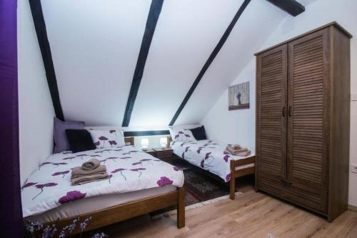a bedroom with two beds in a attic at Apartments for families with children Jakovci Netreticki, Karlovac - 20495 in Netretić