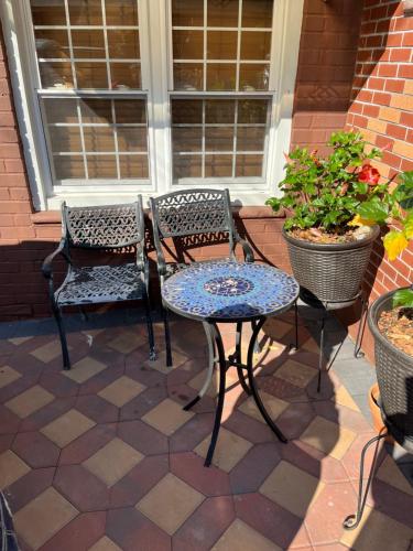 two chairs and a table on a patio at Cozy Place To Stay in Brooklyn in Brooklyn