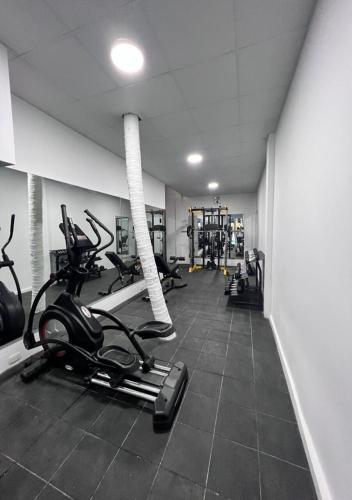 a gym with treadmills and elliptical machines at Hotel El Bosque in Jaén