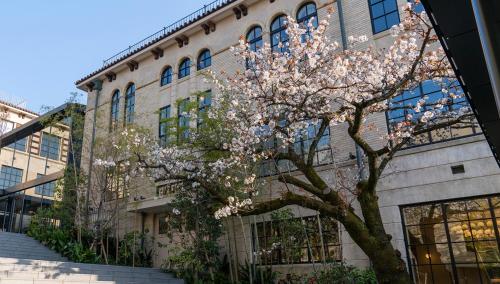 a flowering tree in front of a building at The Hotel Seiryu Kyoto Kiyomizu - a member of the Leading Hotels of the World- in Kyoto
