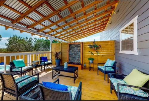 a patio with chairs and tables on a deck at Blue Retreat in the Hill Country in Kerrville
