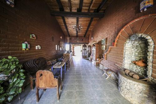 a hallway in a building with a brick wall at Huayápam Yù'ú Lodge in San Andrés Huayapan
