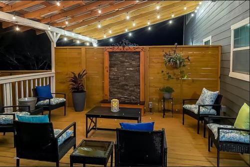 a patio with chairs and tables and a brick wall at Blue Retreat in the Hill Country in Kerrville
