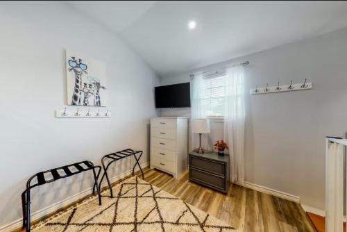 a bedroom with a bed and a dresser and a television at Blue Retreat in the Hill Country in Kerrville