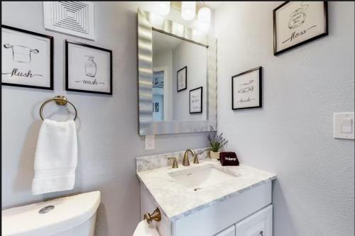 a white bathroom with a sink and a mirror at Blue Retreat in the Hill Country in Kerrville
